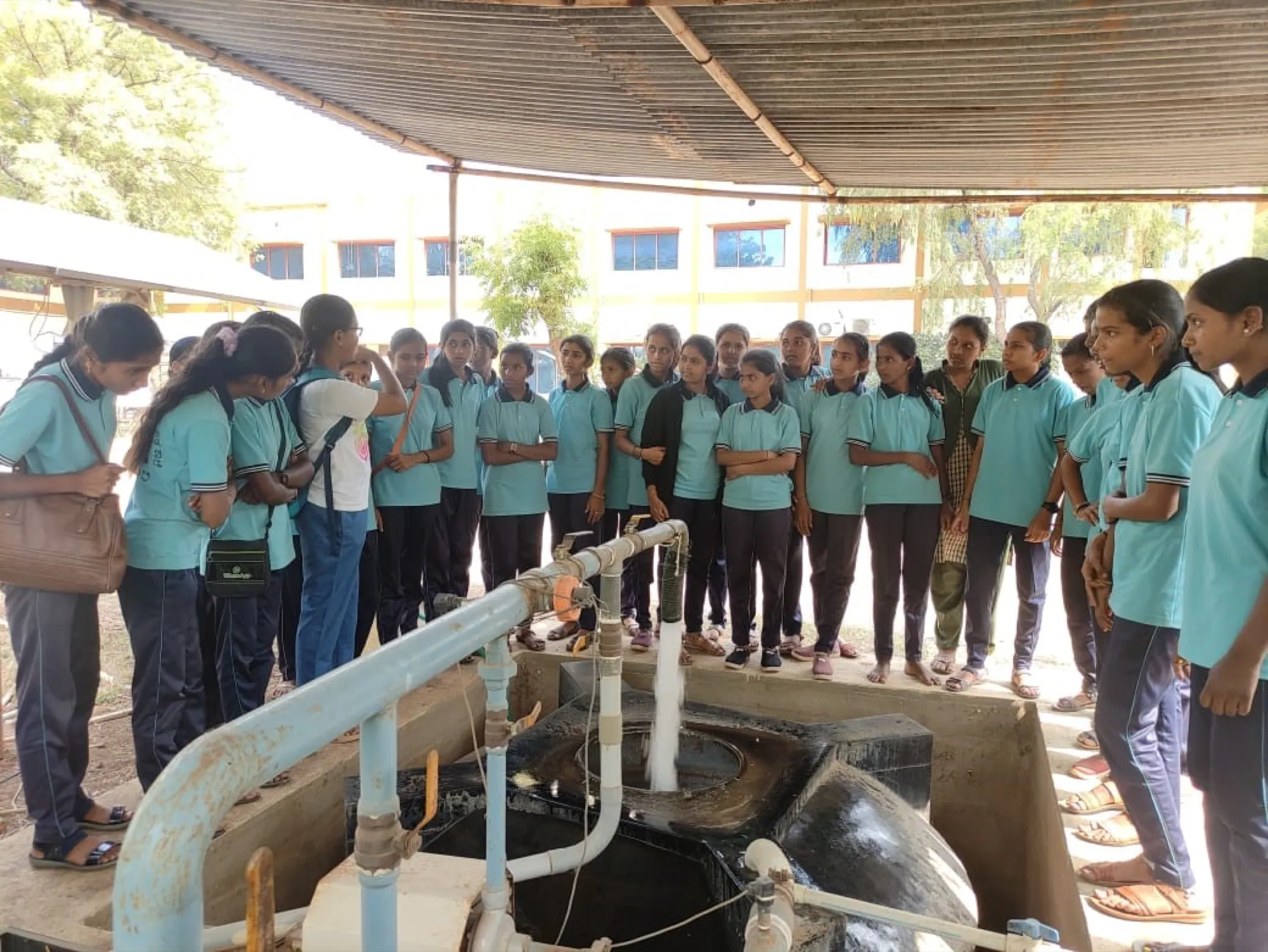 Students observing a solar water-heating / pumping demonstration