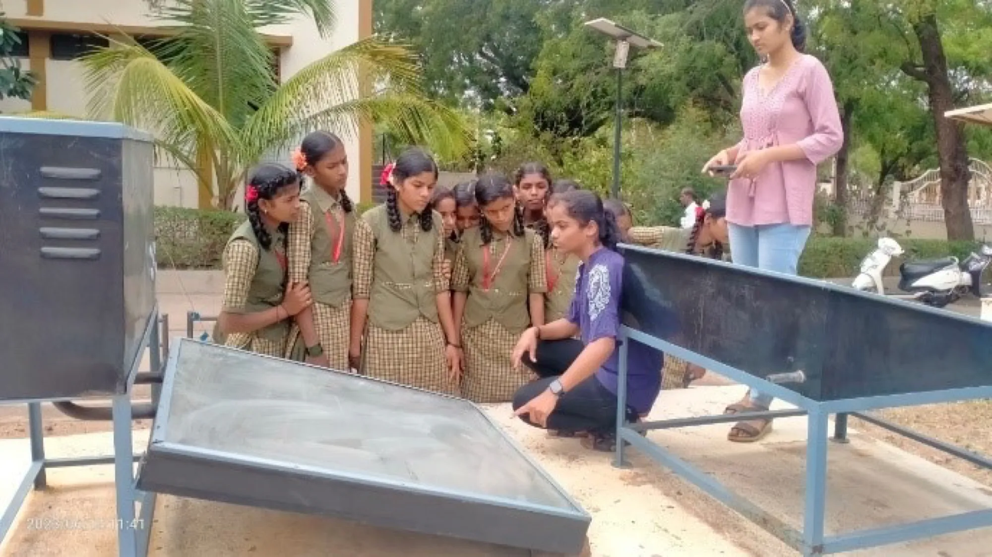 Students at a solar-collector demonstration