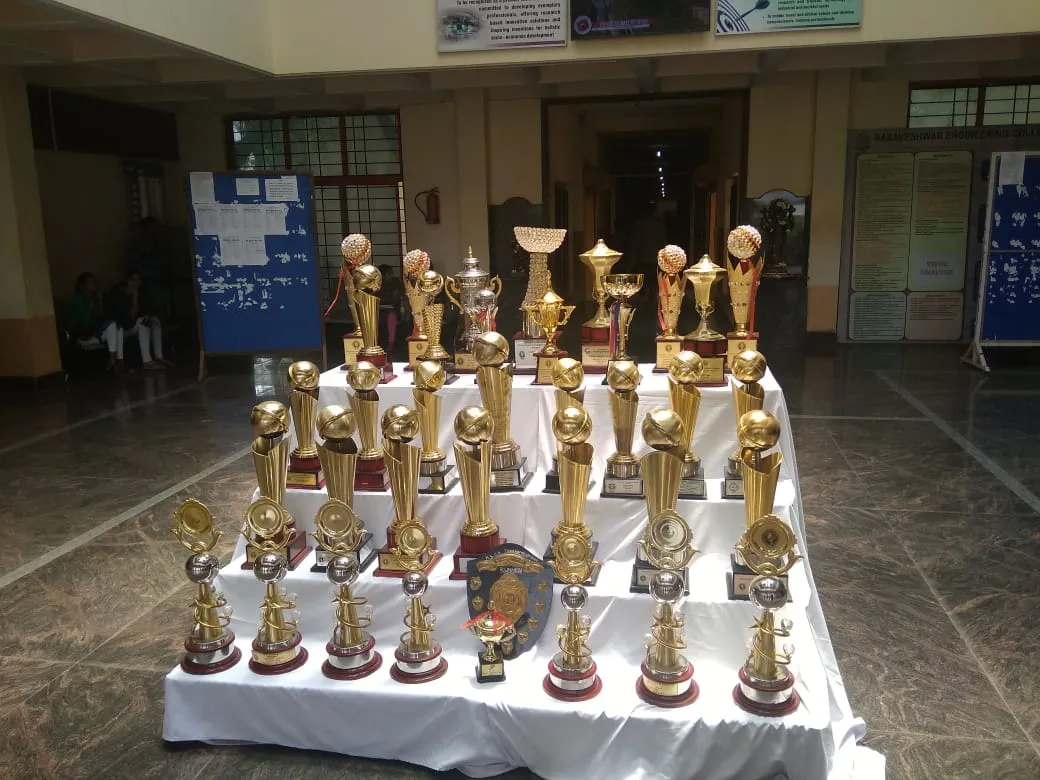 A display of sports trophies and shields won by BEC teams in the college foyer
