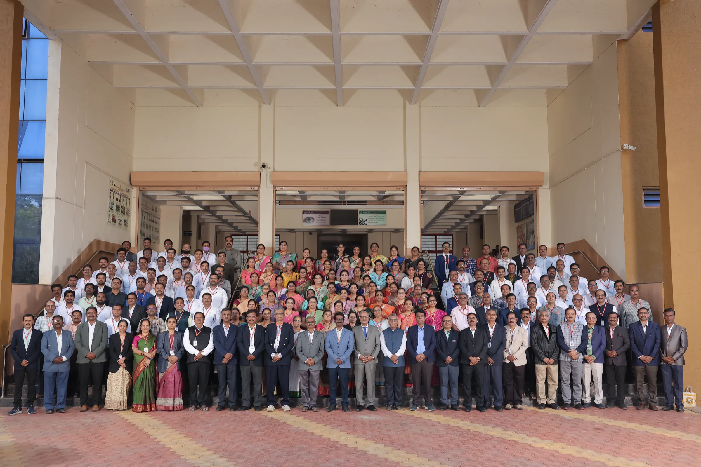 Faculty and staff group photograph at the campus portico