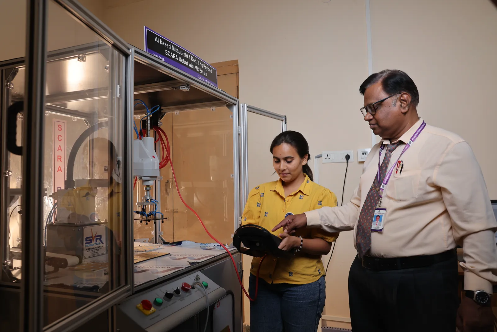 Students demonstrating the SCARA robot workstation
